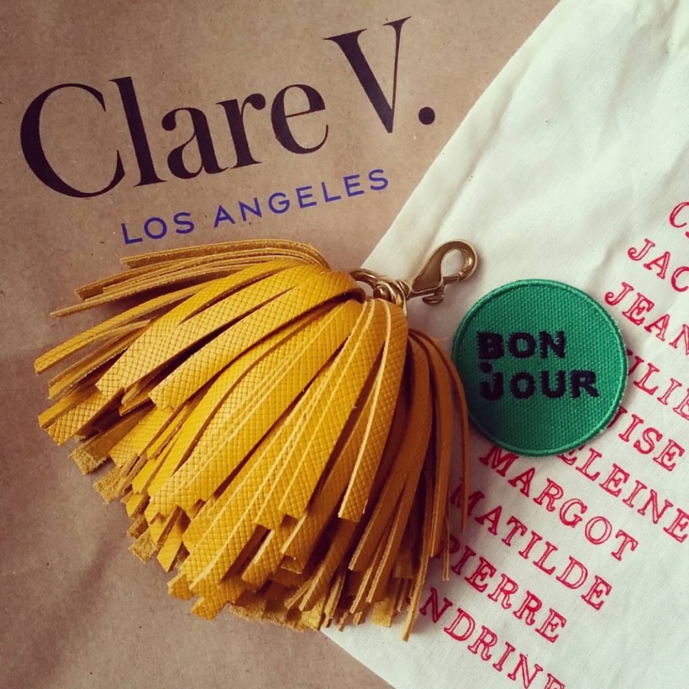 CLARE V leather tassel pompom keychain in yellow